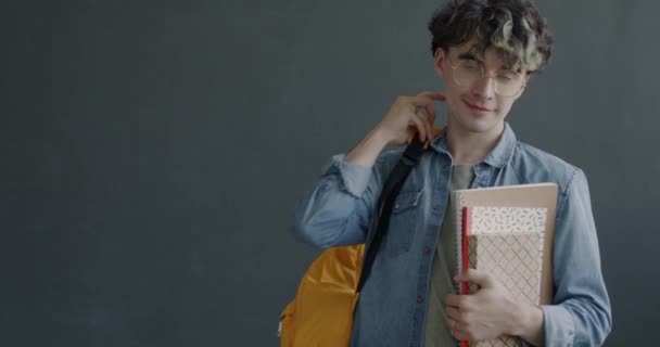 Slow Motion Portrait Cheerful Young Man Student Holding Books Backpack — Stock Video