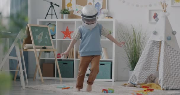 Joyful Kid Wearing Toy Astronaut Helmet Playing Home Having Fun — Stock Video