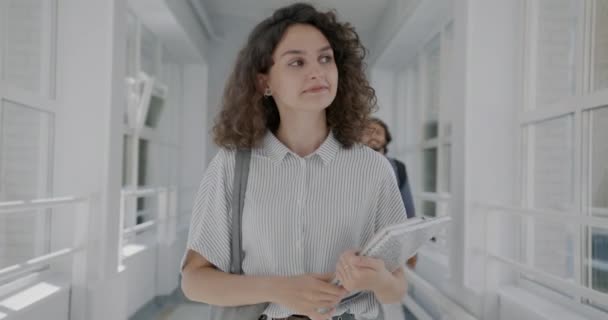 Üniversite Koridorunda Yürüyen Genç Güzel Bir Kadının Sallayarak Insanları Selamladığı — Stok video