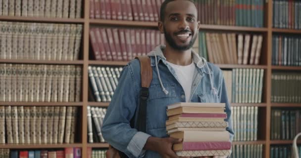 Медленный Портрет Счастливого Афроамериканца Стоящего Библиотеке Колледжа Книгами Выражающими Удовлетворение — стоковое видео