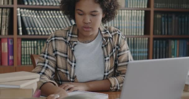 Çalışkan Kız Öğrenci Dizüstü Bilgisayar Kullanarak Kendini Eğitmeye Defterine Yazmaya — Stok video