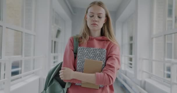 一个心烦意乱的年轻女子拿着书本在高中走廊里走来走去的慢镜头 教育和负面情绪概念 — 图库视频影像