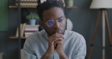 Pensive African American businessman thinking working in office searching creative business solutions. Brainstorming and job concept.