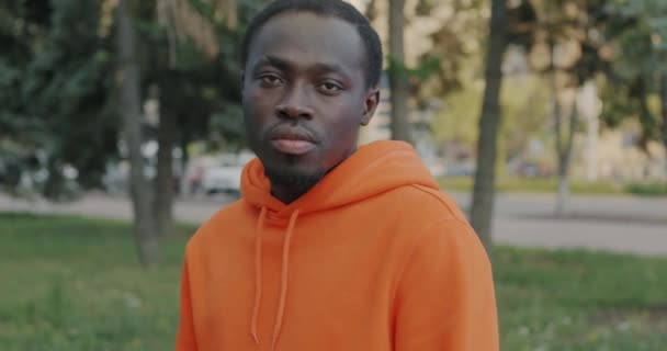 Slow Motion Portrait Emotionless African American Man Hoodie Standing Outdoors — Stock Video