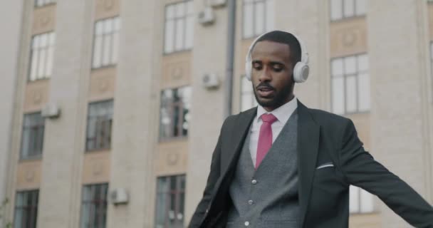 Slow Motion Excited Businessperson Wearing Headphones Walking Dancing Listening Music — Stock Video