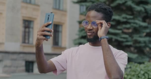 非洲裔美国人的慢镜头在城市街道上摆出一副智能手机相机的样子 人与摄影概念 — 图库视频影像