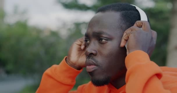 Close Portrait Attractive African American Man Wearing Headphones Listening Music — Stock Video