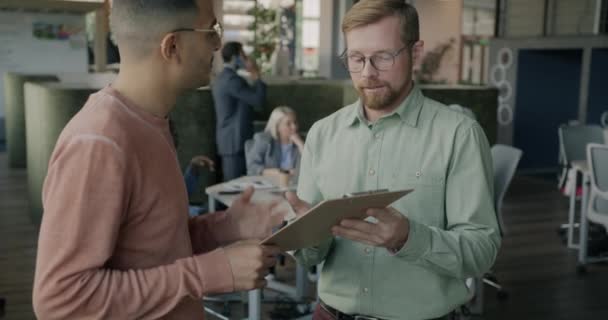 Multiracial Group Coworkers Talking Looking Clipboard Document Open Space Office — Stock Video