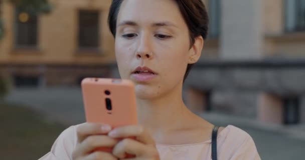 楽しい若い女性がソーシャルメディアをチェックし 街の外でスマートフォン画面に触れる笑い 人と電子機器のコンセプト — ストック動画