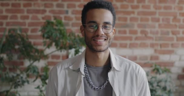 Zpomalený Pohyb Bezstarostného Afroameričana Usmívajícího Kameru Pozadí Kanceláře Cihlové Zdi — Stock video