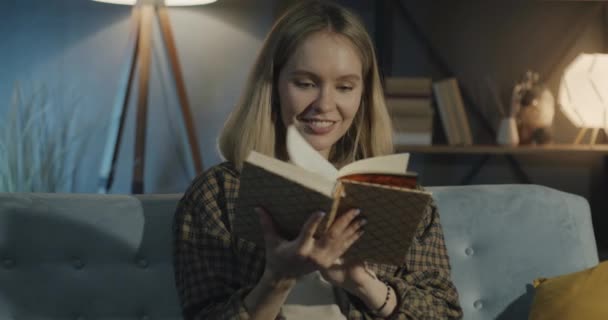 Carefree Young Lady Reading Interesting Book Relaxing Comfortable Couch Dark — Stock Video