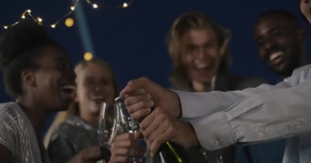 Diverse Group People Opening Bottle Champagne Pouring Glasses Laughing Celebrating — Stock Video