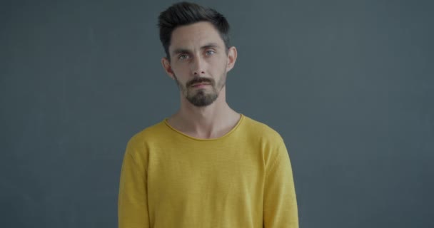 男人摇头挥手拒绝灰色背景的不愉快提议的慢动作肖像 负面情绪和身体语言概念 — 图库视频影像