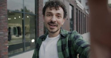 Orta Doğulu neşeli bir adamın açık havada el hareketlerini gösteren online video konuşması yaparken yavaş çekim portresi. İnternet iletişimi ve milenyum kavramı.