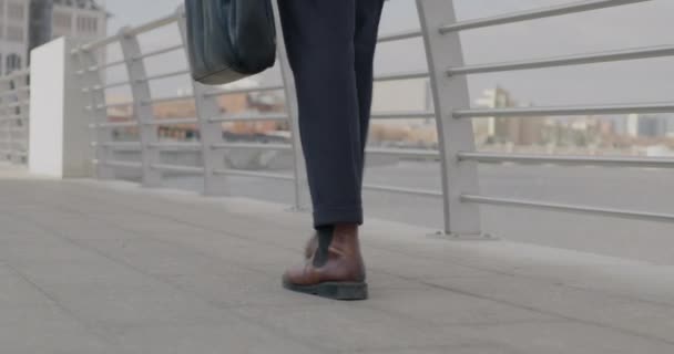 Низькокутний Знімок Чоловічих Ніг Йдуть Вздовж Річкової Набережної Міській Вулиці — стокове відео