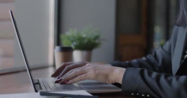Bilgisayarla çalışan ve internet üzerinden iş geliştirme üzerine odaklanan kadın girişimcinin yakın çekim portresi. Modern teknoloji ve iş kadını kavramı.