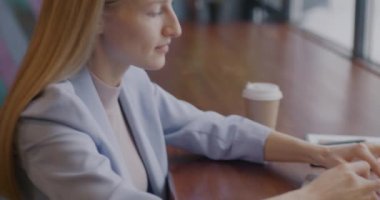 Laptop ile çalışan hırslı genç girişimci bayan kafede internet iletişimine odaklandı. Serbest meslek ve modern teknoloji konsepti.