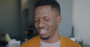 Mutlu Afro-Amerikalı bir adamın portresi mutluluğu ifade ediyor. Evdeki kameraya bakıyor. Pozitif duygu ve insanların kavramı.