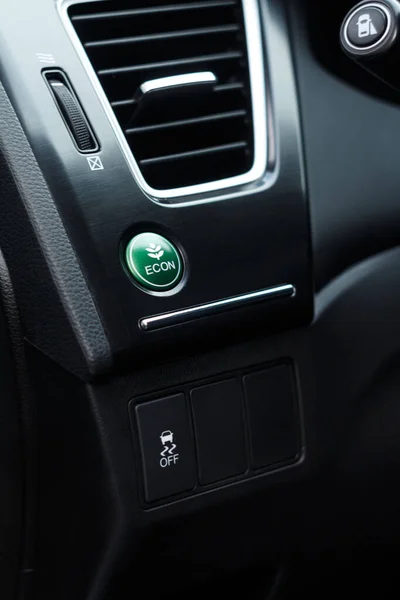 Economic green mode and electronic stability programme buttons in a modern car near air conditioning system