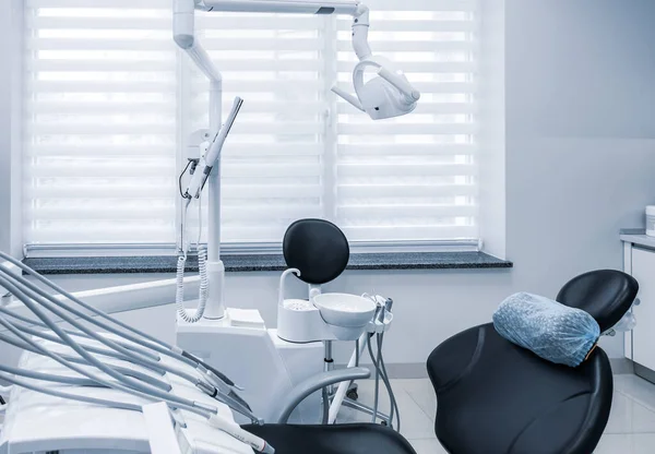 Dental clinic interior with working tools. Dental chair and other accessories