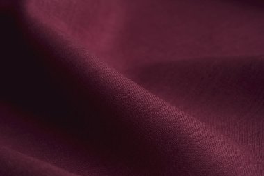 Wrinkled marron linen cloth folded napkins. Linen fabric texture. Concept of using natural eco-friendly materials