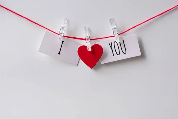 A close up of a sticky note with the word I Love You with red heart. Valentine\'s Day. Valentine\'s Day background. I love you lettering text. Love concept