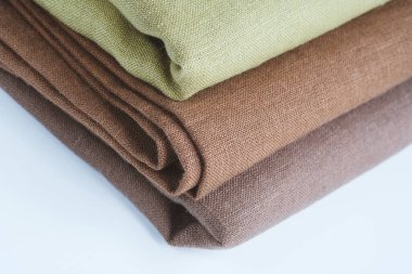 Green and brown linen background. Stripes of fabric