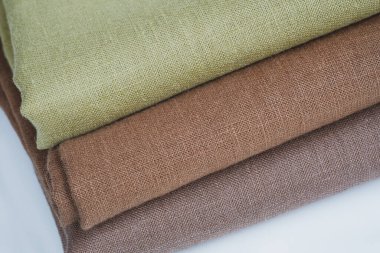 Green and brown linen background. Stripes of fabric