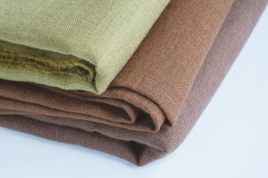 Green and brown linen background. Stripes of fabric