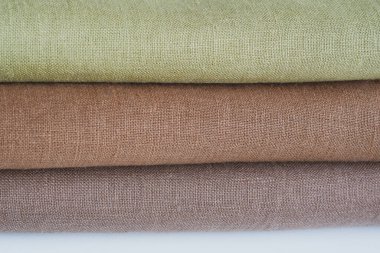 Green and brown linen background. Stripes of fabric
