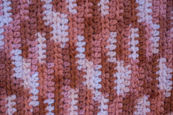 Hand-crocheted plaid. Geometric seamless knitted pattern. The texture is crocheted. Crochet. Knitted background