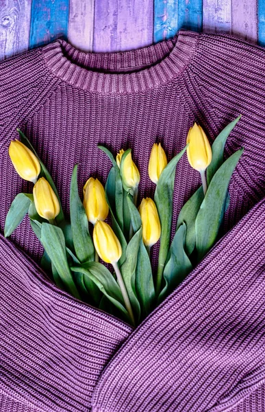 Mother\'s Day or International Women\'s Day. Knitted warm sweater with yellow tulips. Vintage card for moms, girls. Love at a distance, care. Cozy spring concept