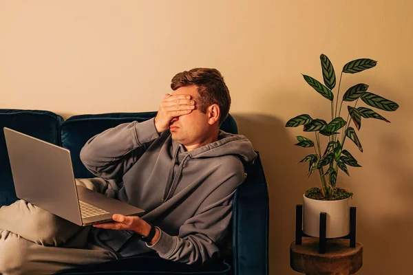 Frustrated Man Lying Couch Laptop Covering Face His Hand Sadness — Foto Stock