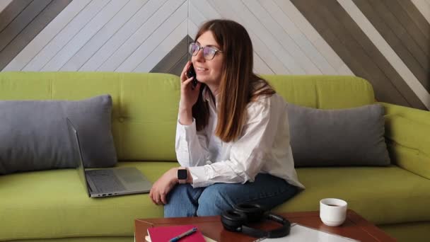 Young Woman Answering Phone Call While Working Living Room Modern — Vídeo de Stock
