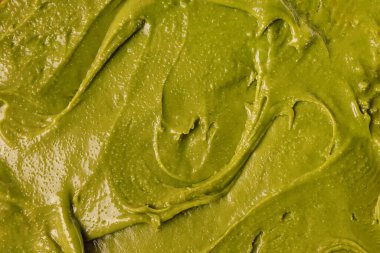 Close-up shot of pistachio paste or spread, green food texture