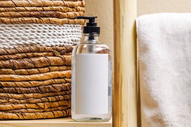 Liquid hand soap in a glass bottle, label mock-up, boho interior