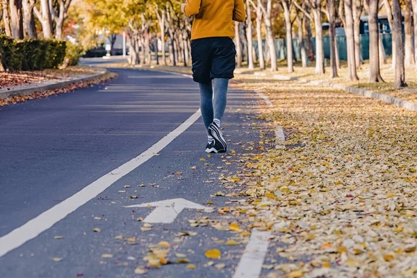 Nohy Nepoznatelného Muže Který Podzim Běhá Venku Žluté Listí Ulici — Stock fotografie