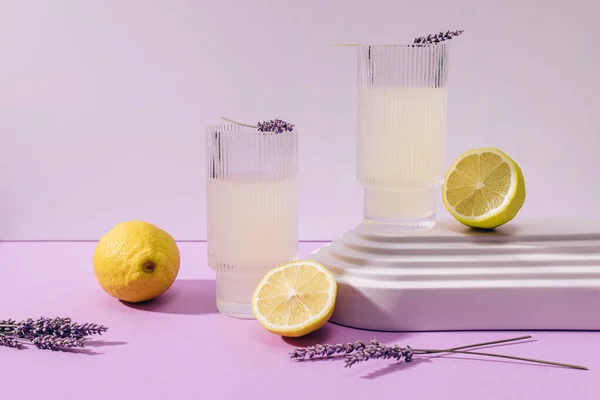Still Life Composition Lavender Lemonade Ribbed Glasses Lemons Purple Background — Stock Photo, Image