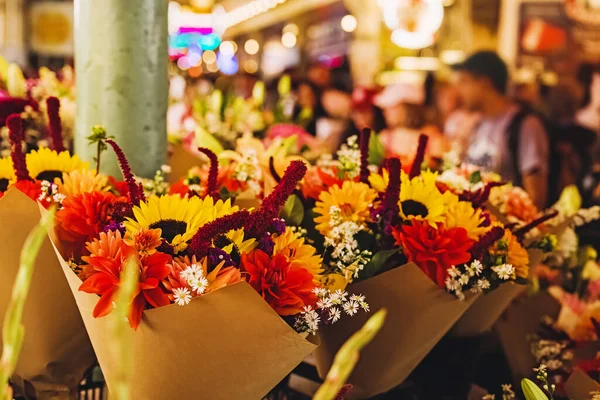 Beautiful fall floral compositions on the market close-up. Autumn flowers bouquets
