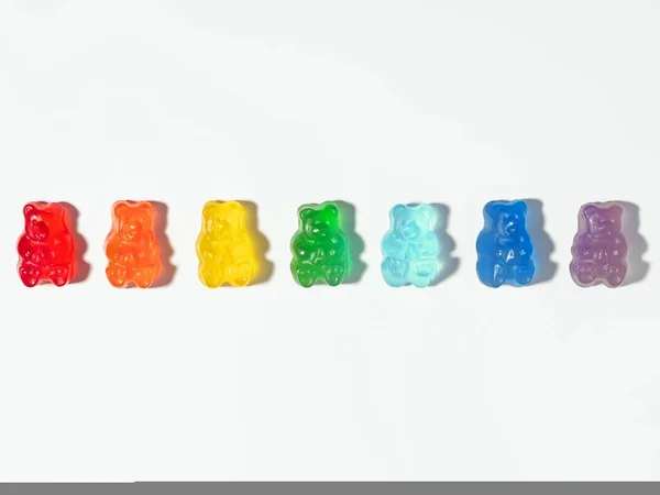 stock image Colorful Gummy bears in rainbow colors, isolated on white background