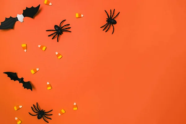 stock image Halloween decor on the orange background, bats, spiders and candy cane