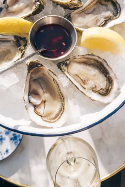 Limon ve sirke sosuyla servis edilen lezzetli taze çiğ istiridye.