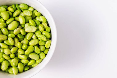 Yeşil buğulanmış soya fasulyesi, hafif masada kabuklu edamame.