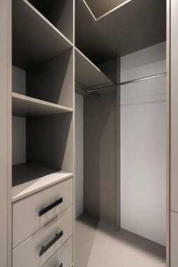 Soyunma odasında rafları olan gardırop.