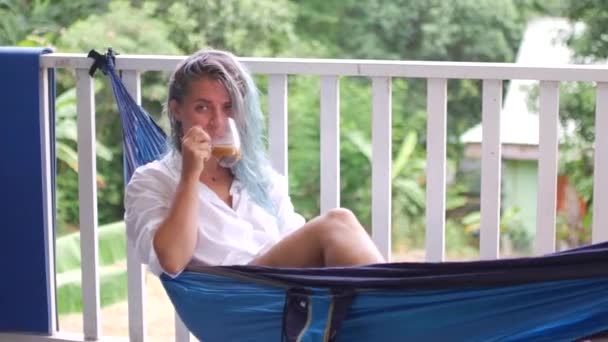 Blonde Woman Swinging Hammock Drinking Coffee — Stock Video