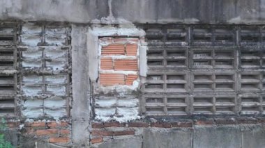 Beton çitlerin, eski tuğlaların ve yıpranmış alçıların karışımından oluşan eski bir duvarın kırsal çekiciliğini keşfedin..