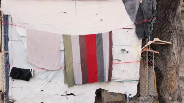 在亚洲贫民窟 毛巾挂在摇摇欲坠 风风雨交加的墙壁上 体现了城市衰败中社区的适应力和足智多谋 — 图库视频影像