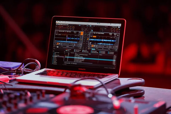 Dj music mixing software Native Instruments Traktor Scratch Pro installed on Macbook Pro. Professional disc jockey setup on concert stage. KYIV-11 AUGUST,2018