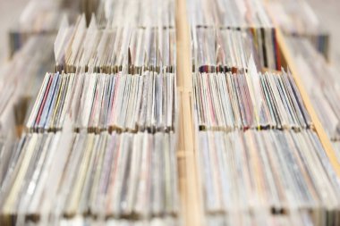 Big stack of vinyl records for turntables in music store. Buy analog record for turn table