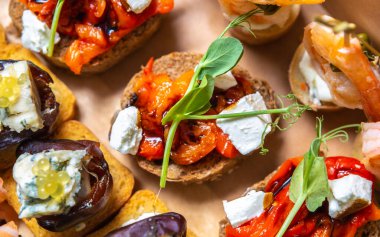 Exotic wine appetizers delivered in a box for venue. Delicious little snacks with cheese and seafood cooked for party